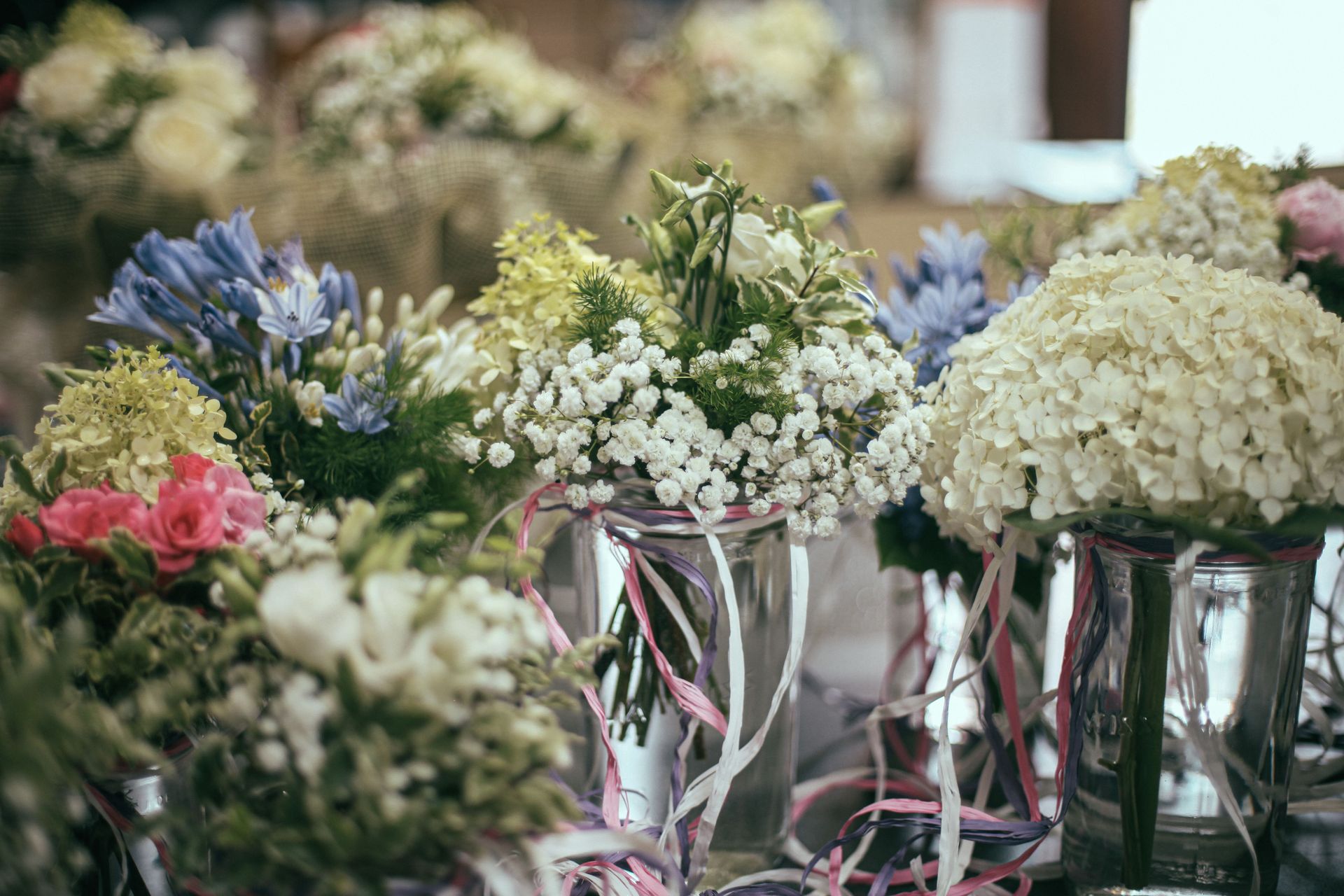 Colorful flower bouquets in glass vases, perfect for decor and celebrations.